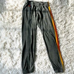 Grey aviator nation sweatpants with rainbow stripes down the side size xs